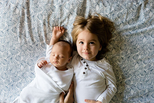 Sibling children laying awake in bed